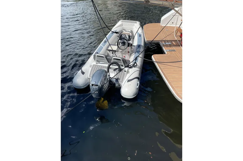 "fortunate" Yacht Photos Pics Inflatable boat moored beside a 1995 JOHNSON 65 Flybridge Motoryacht.