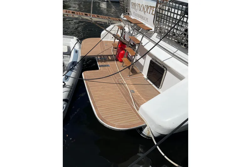 "fortunate" Yacht Photos Pics 1995 JOHNSON 65 Flybridge Motoryacht with teak deck and docked in marina.