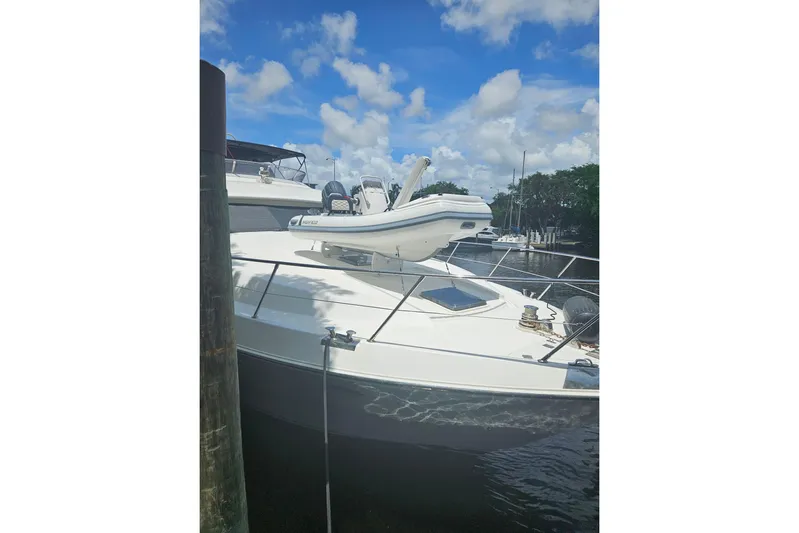 "fortunate" Yacht Photos Pics 1995 JOHNSON 65 Flybridge Motoryacht docked under blue sky.