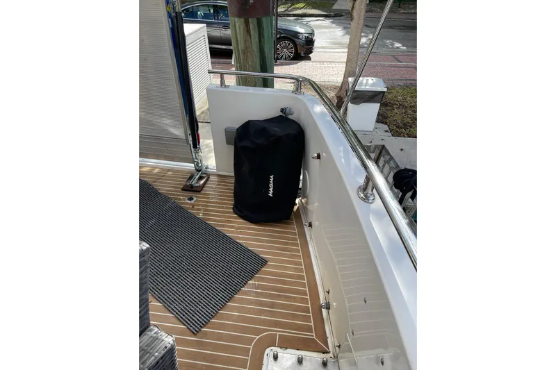 "fortunate" Yacht Photos Pics 1995 JOHNSON 65 Flybridge Motoryacht deck with covered equipment and wooden flooring.