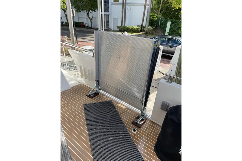 "fortunate" Yacht Photos Pics 1995 JOHNSON 65 Flybridge Motoryacht deck with metal gate and wooden flooring.