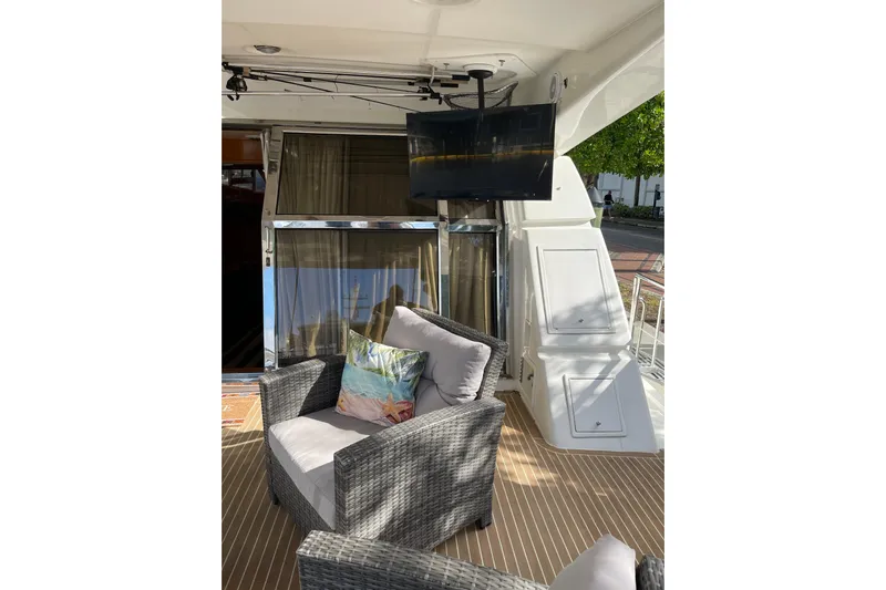 "fortunate" Yacht Photos Pics Luxurious 1995 JOHNSON 65 Flybridge Motoryacht with cozy seating and mounted TV.