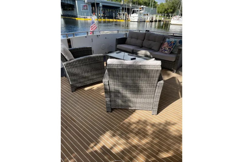 "fortunate" Yacht Photos Pics Outdoor seating on 1995 JOHNSON 65 Flybridge Motoryacht, docked at marina.