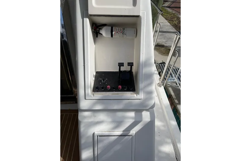 "fortunate" Yacht Photos Pics Control panel on a 1995 JOHNSON 65 Flybridge Motoryacht with fire extinguisher.