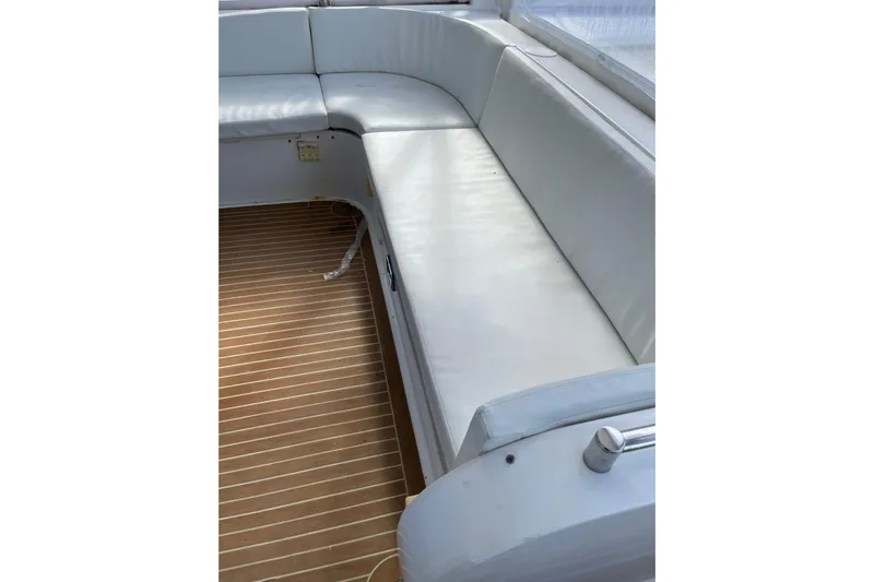 "fortunate" Yacht Photos Pics Luxurious seating area on 1995 JOHNSON 65 Flybridge Motoryacht with wooden flooring.