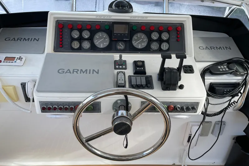 "fortunate" Yacht Photos Pics Control panel of a 1995 JOHNSON 65 Flybridge Motoryacht with Garmin navigation equipment.