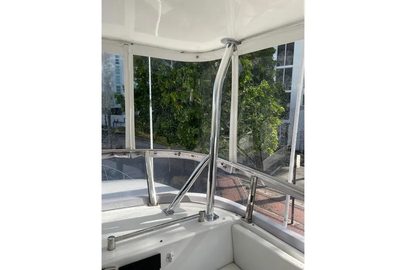 "fortunate" Yacht Photos Pics Interior view of 1995 JOHNSON 65 Flybridge Motoryacht with chrome railing and clear windows.