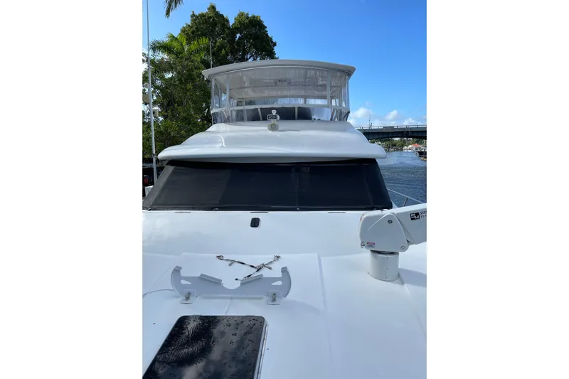 "fortunate" Yacht Photos Pics 1995 JOHNSON 65 Flybridge Motoryacht on water, showcasing sleek design and spacious deck.