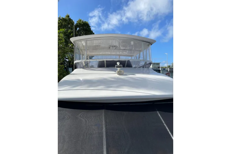 "fortunate" Yacht Photos Pics 1995 JOHNSON 65 Flybridge Motoryacht, front view under clear blue sky.