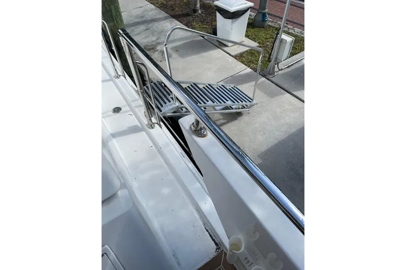 "fortunate" Yacht Photos Pics 1995 JOHNSON 65 Flybridge Motoryacht with stainless steel railings and dockside view.