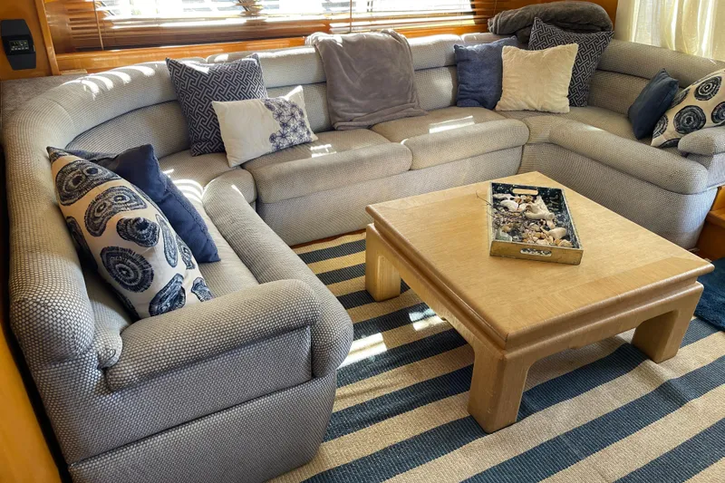 "fortunate" Yacht Photos Pics Luxurious interior of 1995 JOHNSON 65 Flybridge Motoryacht with cozy seating and decorative pillows.