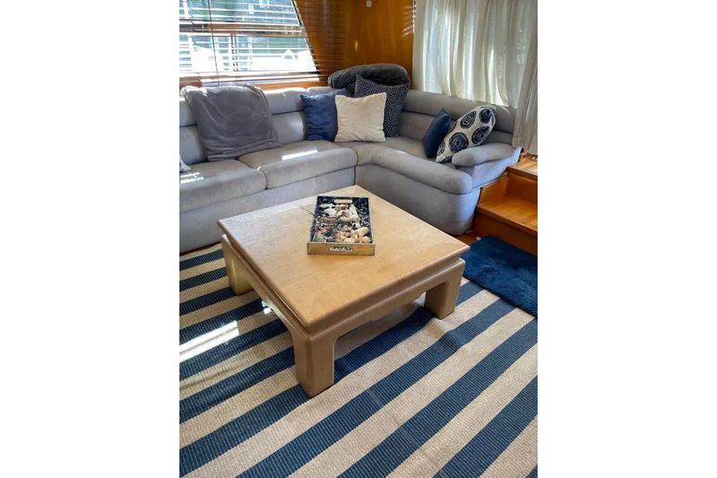 "fortunate" Yacht Photos Pics Luxurious interior of 1995 JOHNSON 65 Flybridge Motoryacht with cozy seating and elegant decor.