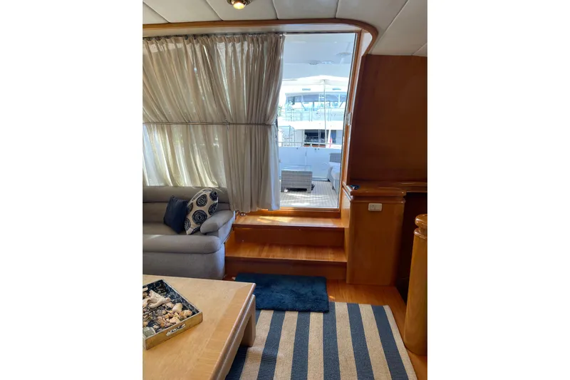 "fortunate" Yacht Photos Pics Interior of 1995 JOHNSON 65 Flybridge Motoryacht with cozy seating and nautical decor.