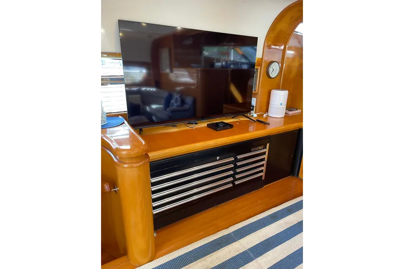 "fortunate" Yacht Photos Pics Luxurious interior of 1995 JOHNSON 65 Flybridge Motoryacht with TV and wooden cabinetry.