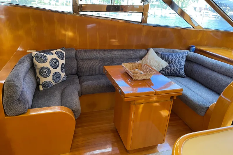 "fortunate" Yacht Photos Pics Luxurious 1995 JOHNSON 65 Flybridge Motoryacht interior with cozy seating and elegant wood finish.