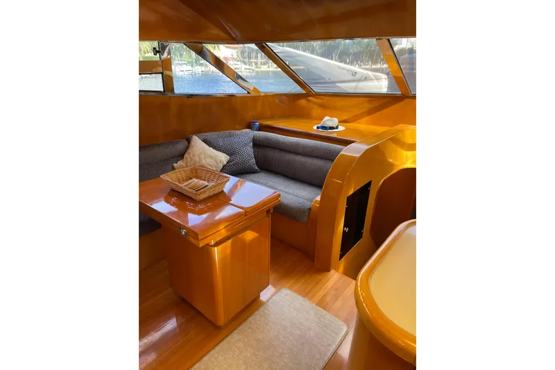"fortunate" Yacht Photos Pics Luxurious interior of 1995 JOHNSON 65 Flybridge Motoryacht with wooden finishes and cozy seating.