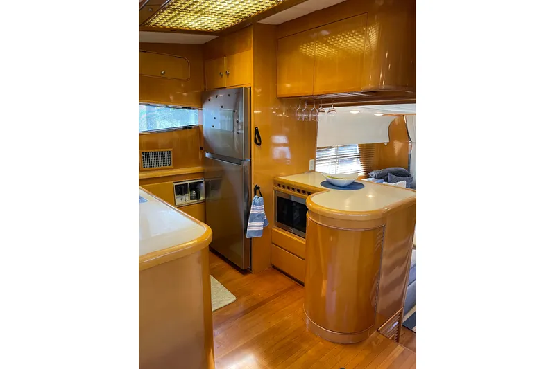 "fortunate" Yacht Photos Pics Luxurious 1995 JOHNSON 65 Flybridge Motoryacht kitchen with wood cabinetry and modern appliances.