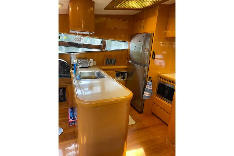 "fortunate" Yacht Photos Pics Luxurious kitchen interior of 1995 JOHNSON 65 Flybridge Motoryacht with modern amenities.