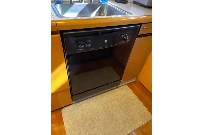 "fortunate" Yacht Photos Pics Kitchen area with dishwasher and sink on a 1995 JOHNSON 65 Flybridge Motoryacht.