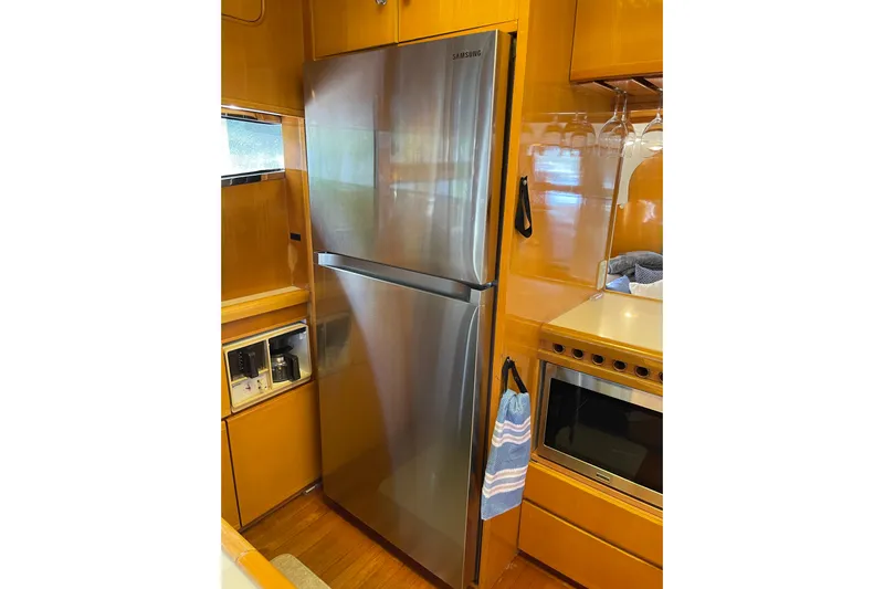 "fortunate" Yacht Photos Pics Stainless steel refrigerator in 1995 JOHNSON 65 Flybridge Motoryacht kitchen.