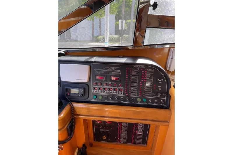 "fortunate" Yacht Photos Pics Control panel of a 1995 JOHNSON 65 Flybridge Motoryacht, featuring navigation and communication equipment.