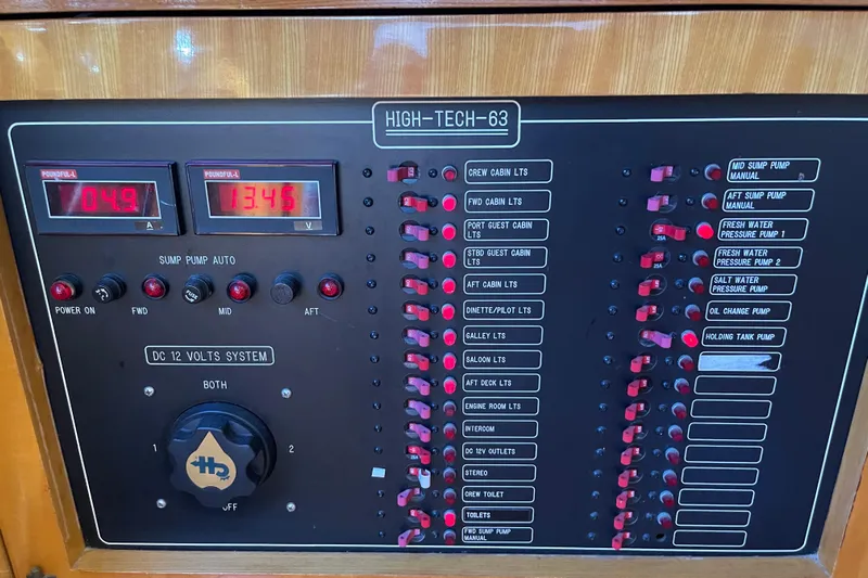 "fortunate" Yacht Photos Pics Control panel of a 1995 JOHNSON 65 Flybridge Motoryacht with various switches and indicators.