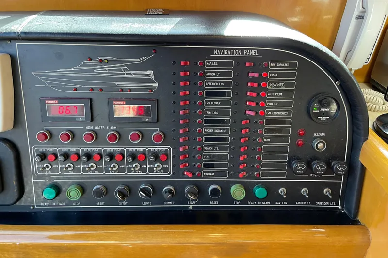 "fortunate" Yacht Photos Pics Control panel of a 1995 JOHNSON 65 Flybridge Motoryacht with navigation and system switches.