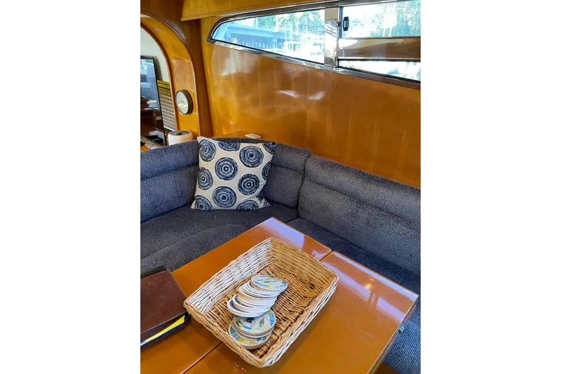 "fortunate" Yacht Photos Pics Luxurious interior of 1995 JOHNSON 65 Flybridge Motoryacht with cozy seating and decorative pillow.