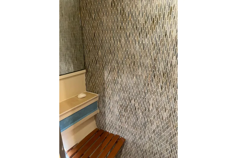 "fortunate" Yacht Photos Pics Interior of 1995 JOHNSON 65 Flybridge Motoryacht with textured wall and wooden seat.