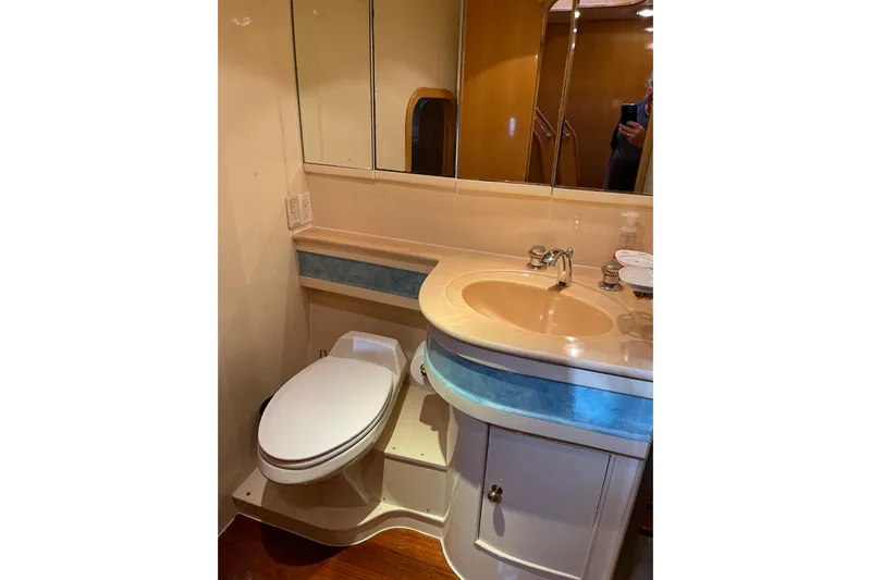 "fortunate" Yacht Photos Pics Bathroom interior of 1995 JOHNSON 65 Flybridge Motoryacht with sink and toilet.
