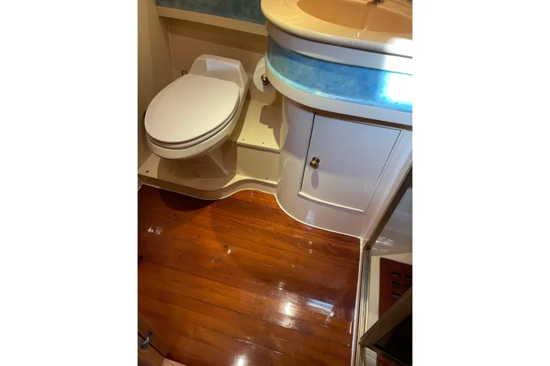 "fortunate" Yacht Photos Pics Luxurious bathroom in 1995 JOHNSON 65 Flybridge Motoryacht with polished wood flooring.