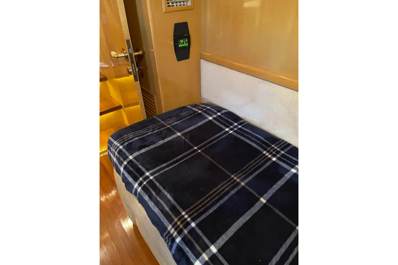 "fortunate" Yacht Photos Pics Cozy cabin interior of 1995 JOHNSON 65 Flybridge Motoryacht with plaid bedding.