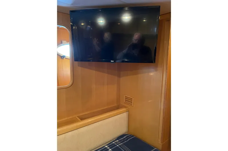 "fortunate" Yacht Photos Pics Flat-screen TV in the cabin of a 1995 JOHNSON 65 Flybridge Motoryacht.