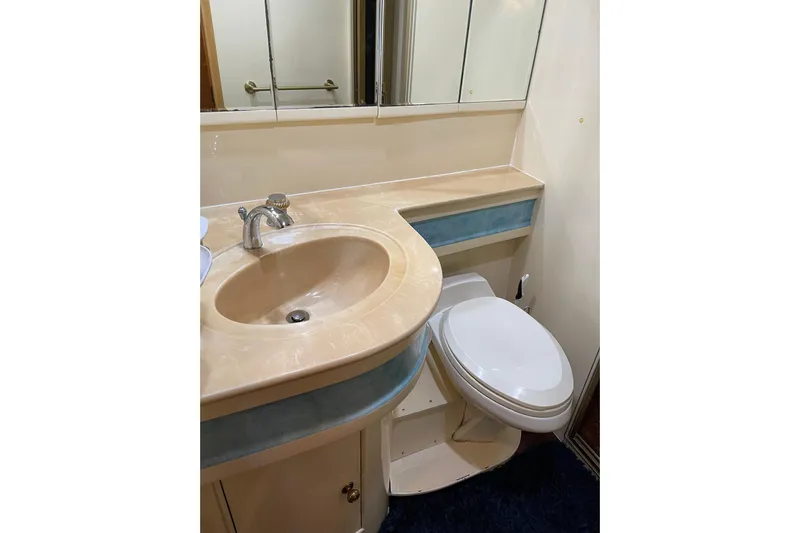 "fortunate" Yacht Photos Pics Bathroom interior of 1995 JOHNSON 65 Flybridge Motoryacht with sink and toilet.