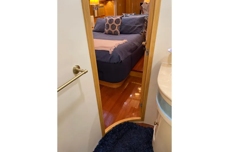 "fortunate" Yacht Photos Pics Luxurious bedroom interior of 1995 JOHNSON 65 Flybridge Motoryacht with elegant bedding.