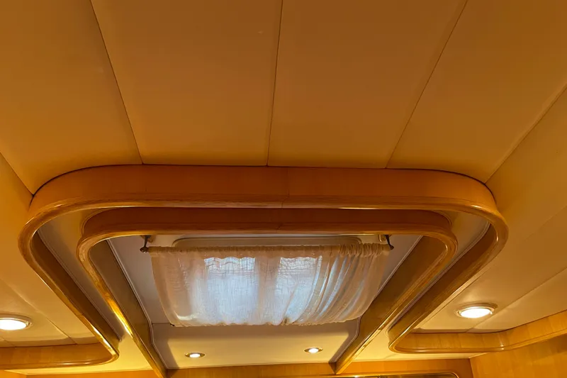 "fortunate" Yacht Photos Pics Ceiling interior of 1995 JOHNSON 65 Flybridge Motoryacht with elegant wood trim and lighting.