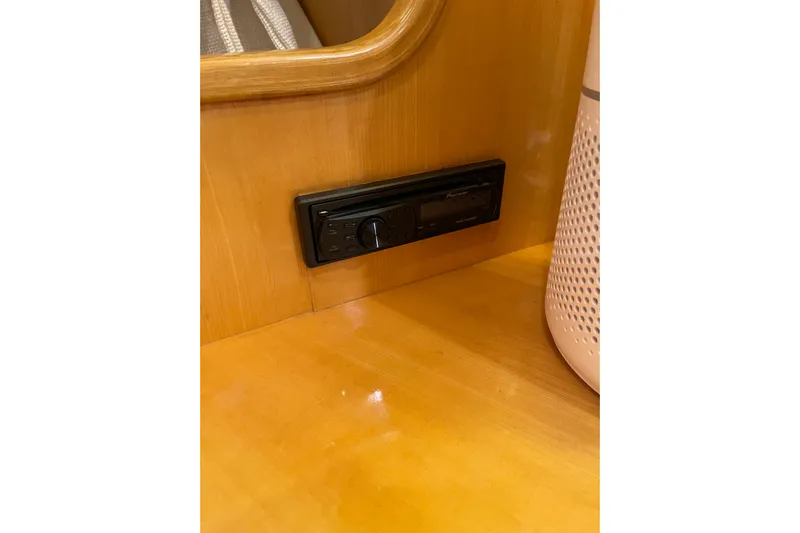 "fortunate" Yacht Photos Pics Built-in stereo system on 1995 JOHNSON 65 Flybridge Motoryacht, wooden interior detail.