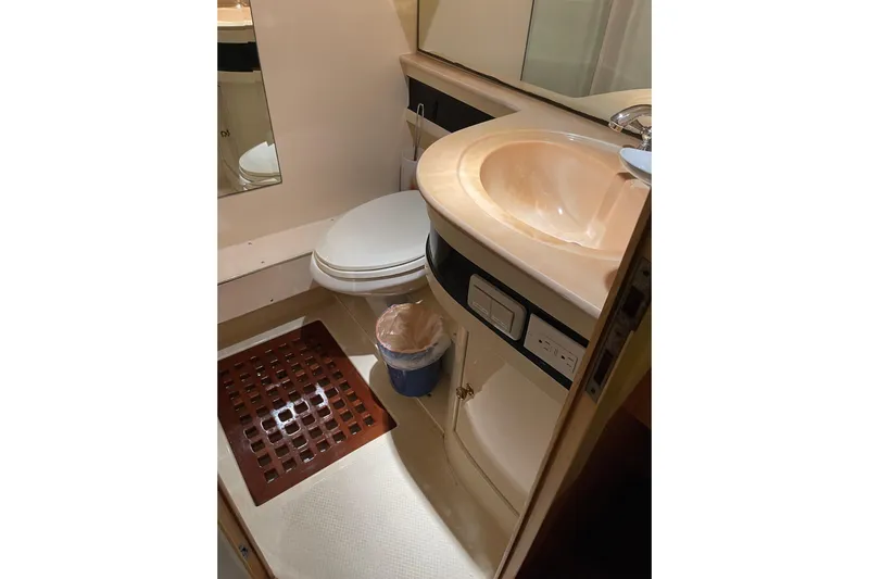 "fortunate" Yacht Photos Pics Bathroom interior of 1995 JOHNSON 65 Flybridge Motoryacht, featuring sink and toilet.