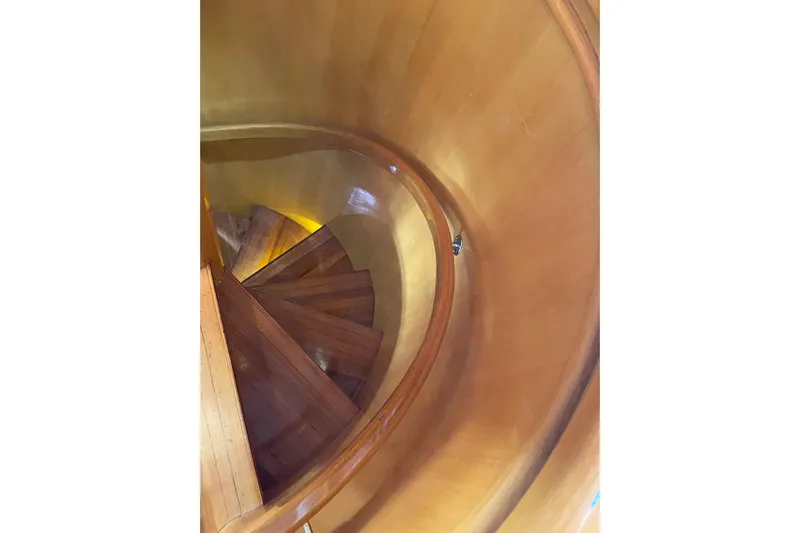 "fortunate" Yacht Photos Pics Curved wooden staircase inside 1995 JOHNSON 65 Flybridge Motoryacht.