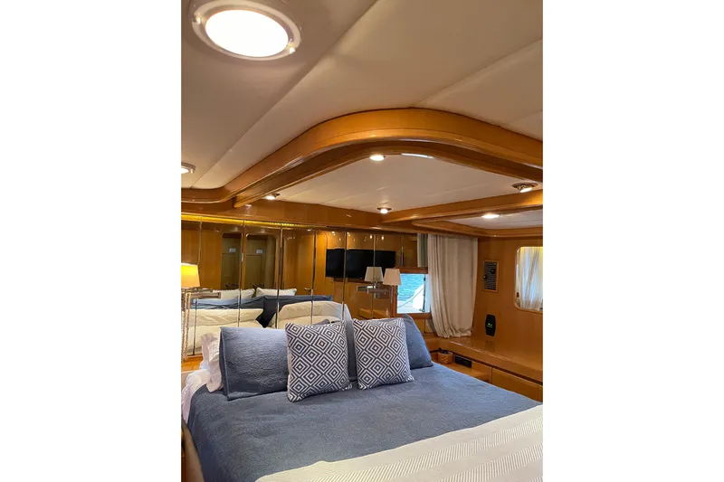"fortunate" Yacht Photos Pics Luxurious bedroom interior of 1995 JOHNSON 65 Flybridge Motoryacht with elegant wood finish.