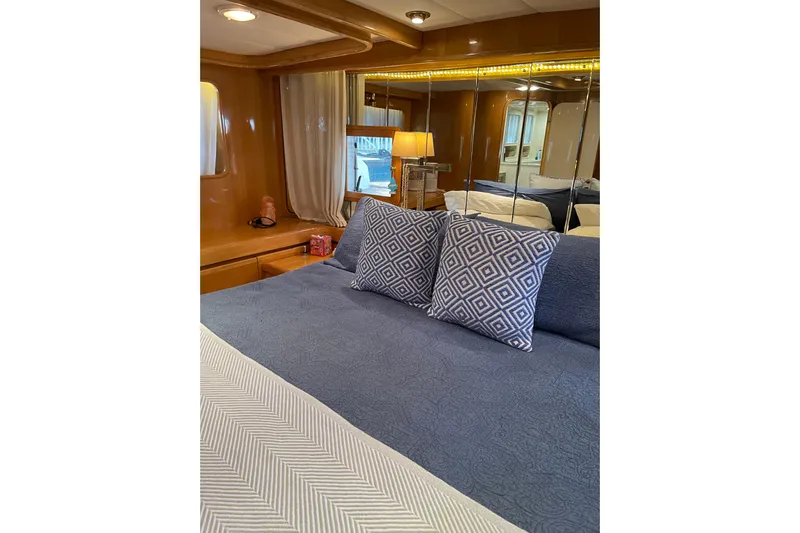 "fortunate" Yacht Photos Pics Luxurious bedroom interior of 1995 JOHNSON 65 Flybridge Motoryacht with elegant decor.