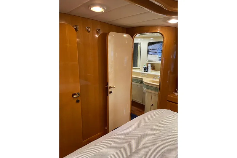 "fortunate" Yacht Photos Pics Luxurious interior of 1995 JOHNSON 65 Flybridge Motoryacht with wooden finishes and ensuite bathroom.