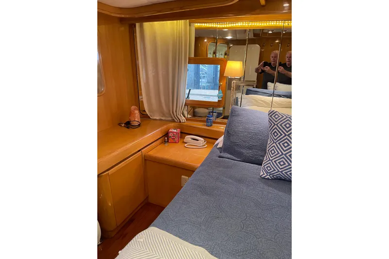 "fortunate" Yacht Photos Pics Luxurious bedroom interior of 1995 JOHNSON 65 Flybridge Motoryacht with elegant wood finish.