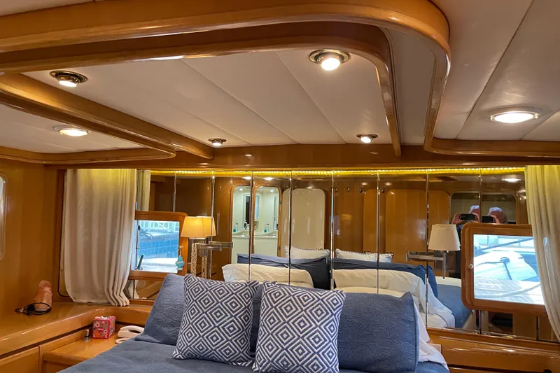 "fortunate" Yacht Photos Pics Luxurious bedroom interior of 1995 JOHNSON 65 Flybridge Motoryacht with elegant wood finishes.