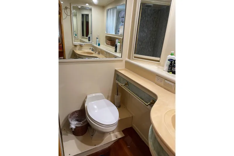 "fortunate" Yacht Photos Pics Bathroom interior of 1995 JOHNSON 65 Flybridge Motoryacht, featuring toilet and sink.