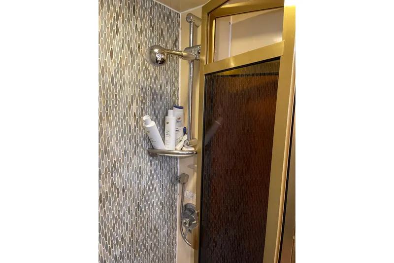 "fortunate" Yacht Photos Pics Shower area in 1995 JOHNSON 65 Flybridge Motoryacht with modern fixtures and toiletries.