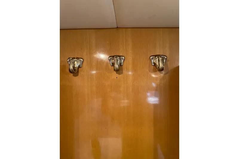 "fortunate" Yacht Photos Pics Three elephant-shaped hooks on wooden panel, JOHNSON 65 Flybridge Motoryacht, 1995.