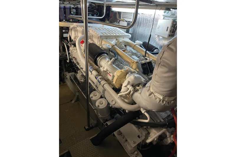 "fortunate" Yacht Photos Pics Engine room of 1995 JOHNSON 65 Flybridge Motoryacht, showcasing detailed machinery components.