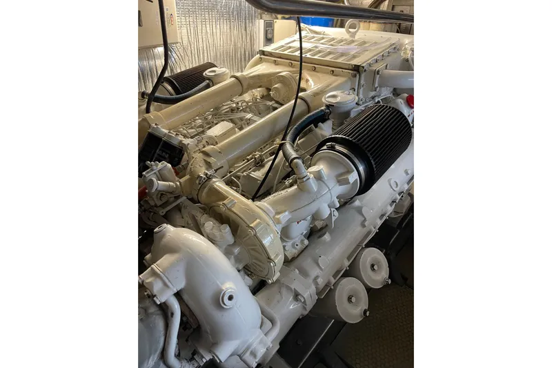 "fortunate" Yacht Photos Pics Engine room of 1995 JOHNSON 65 Flybridge Motoryacht, showcasing detailed machinery components.