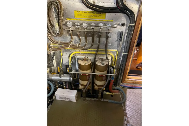 "fortunate" Yacht Photos Pics Engine room of 1995 JOHNSON 65 Flybridge Motoryacht with fuel filter system and gauges.